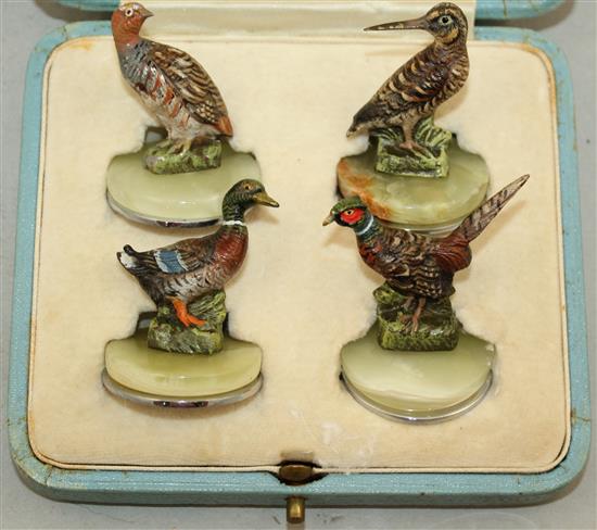 A set of four cold painted bronze menu holders, largest 1.5in.